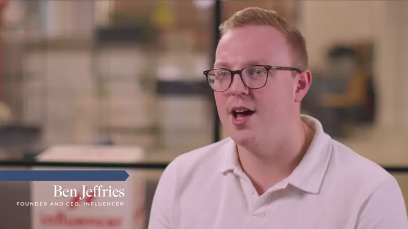 A man wearing glasses and a white polo shirt speaks in an office setting. Text reads: Ben Jeffries, Founder and CEO, Influencer.